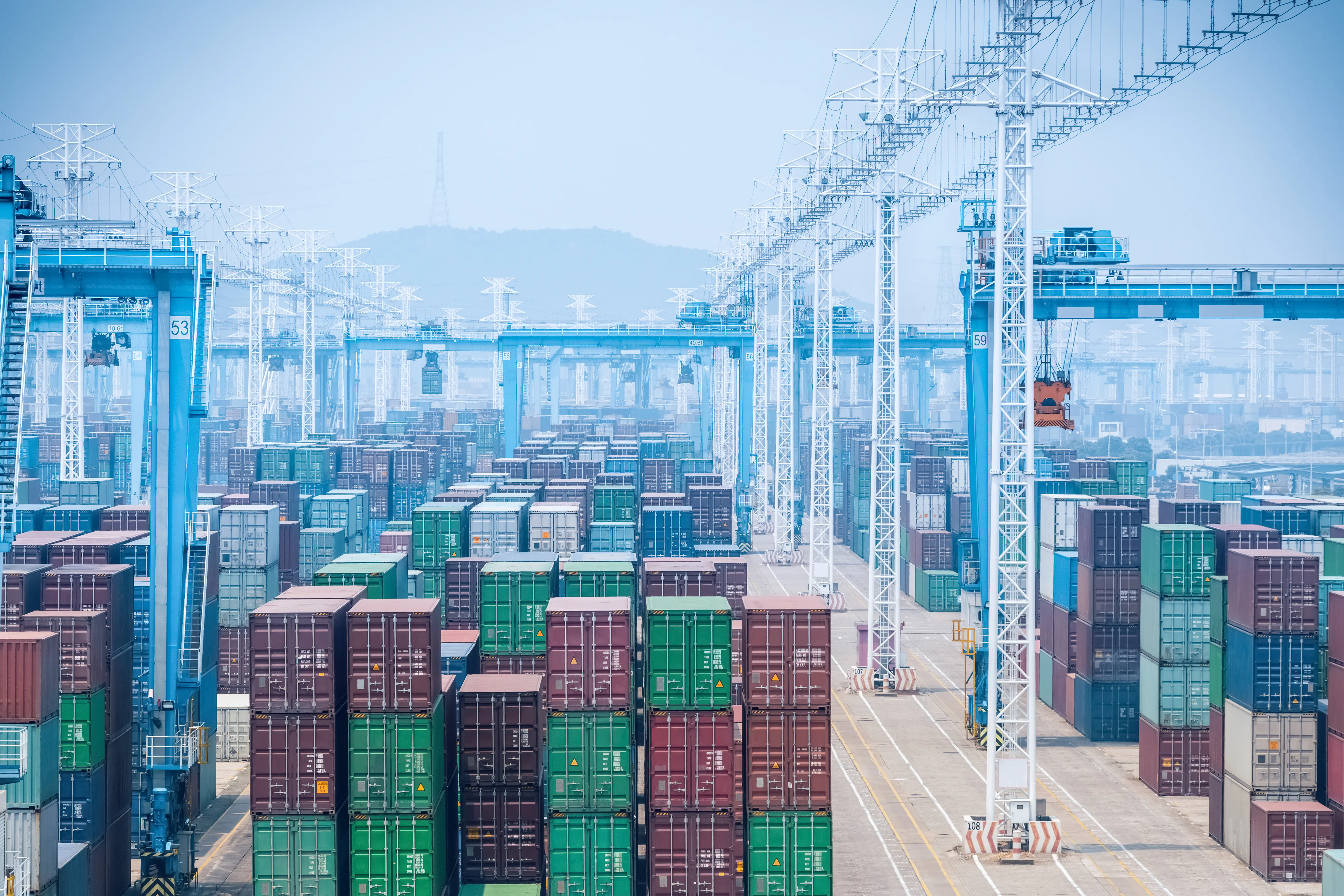 Cargo containers stacked at a shipping port.