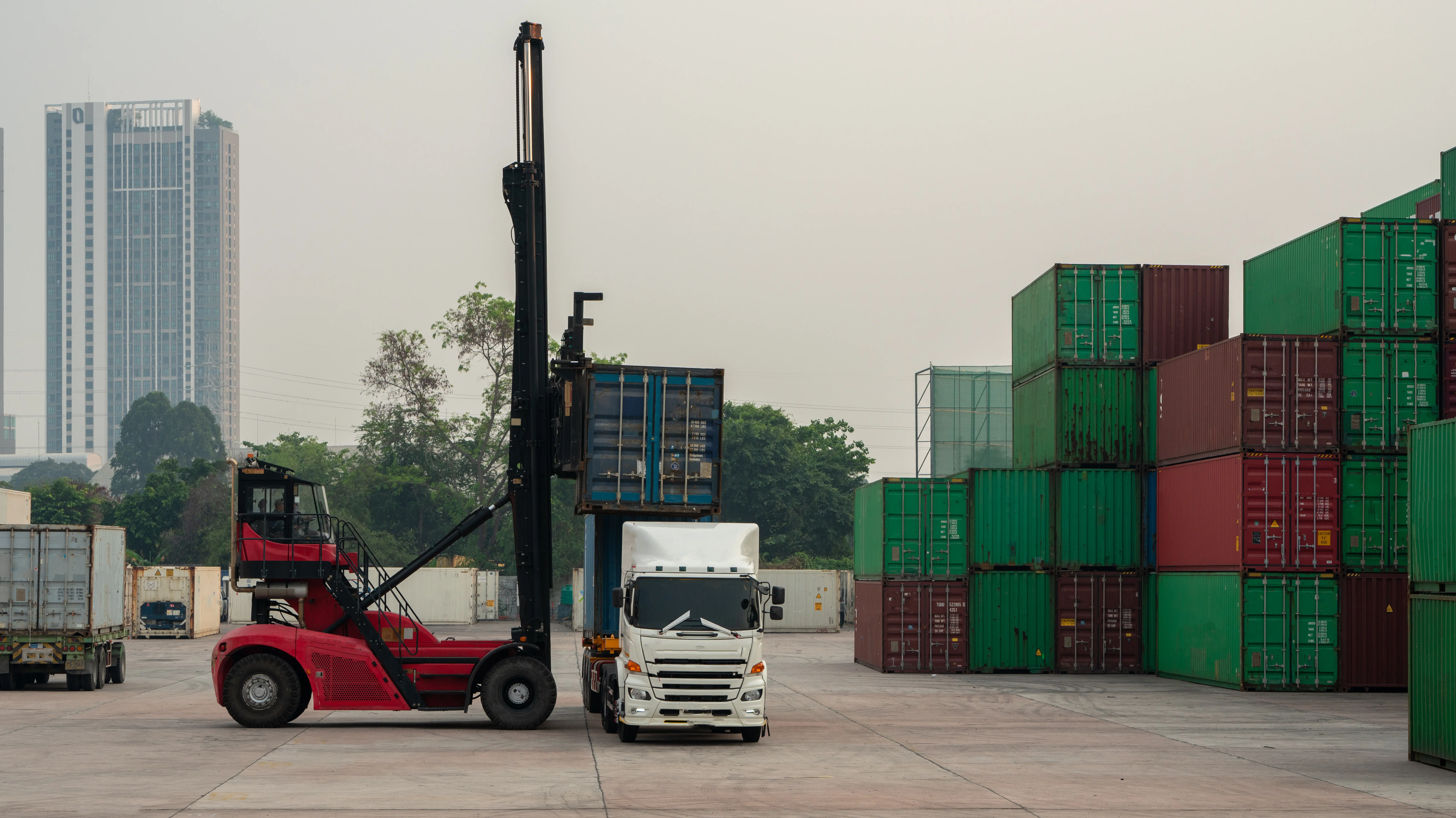 Forklift loading a container onto a cargo truck.